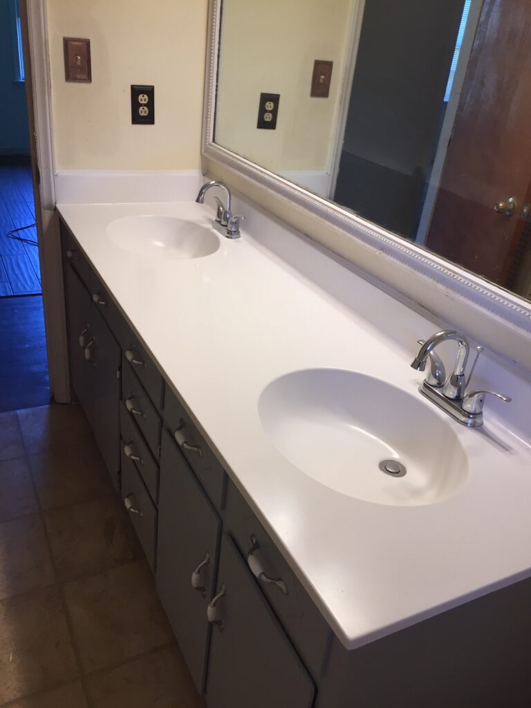 Same countertop after a gloss white urethane resurface, Cabinetry was also refinished, giving the vanity a fresh beautiful new look!  (AFTER)