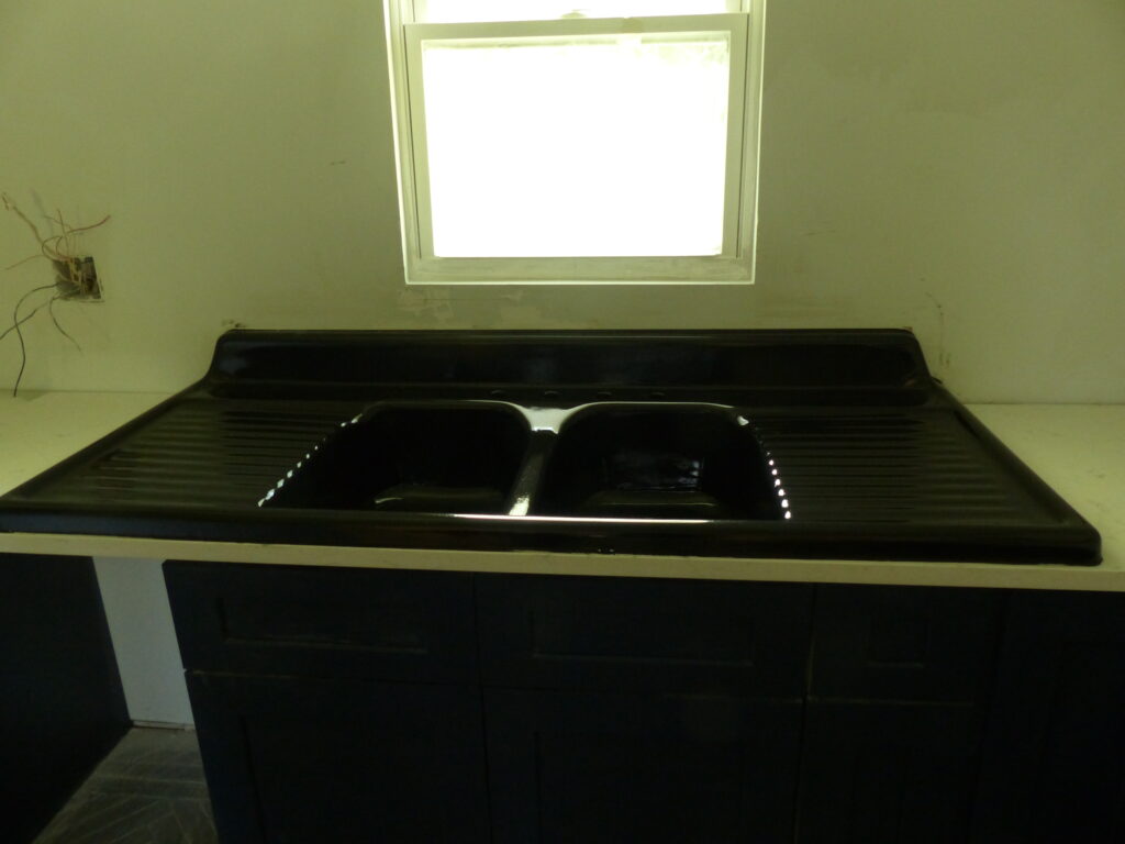 Beautiful new-look cast-iron kitchen sink after a black gloss urethane resurface (AFTER)