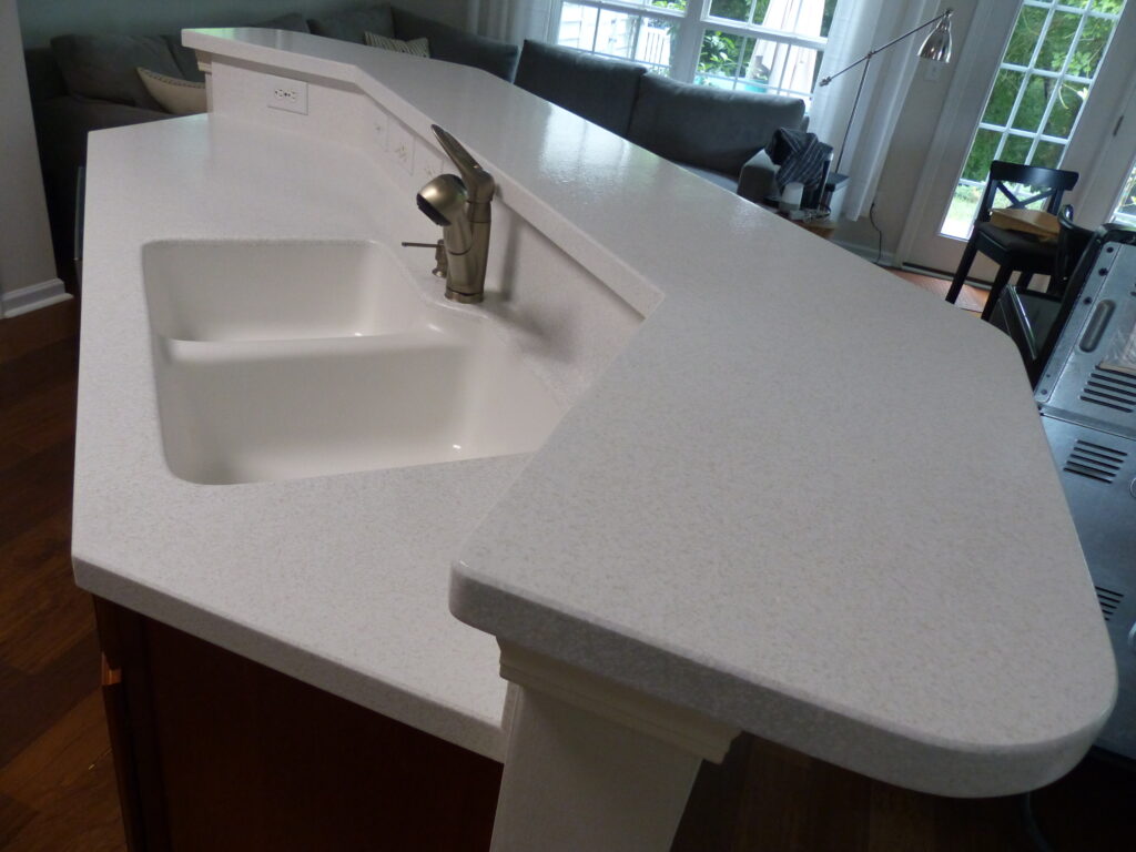 The homeowner chose to have his countertop resurfaced in a "White Sands" multifleck finish, with a satin topcoat (AFTER)
