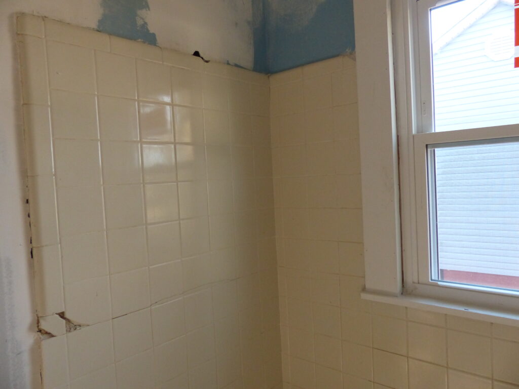 Bathroom Tiled Surround with cracks and chips in tiles