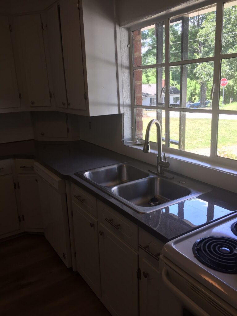 The investor chose to resurface the backsplash in a white, while the countertop was resurfaced in a "Galena Gray" multifleck, topcoated with a clear high-gloss pour-on epoxy (AFTER)