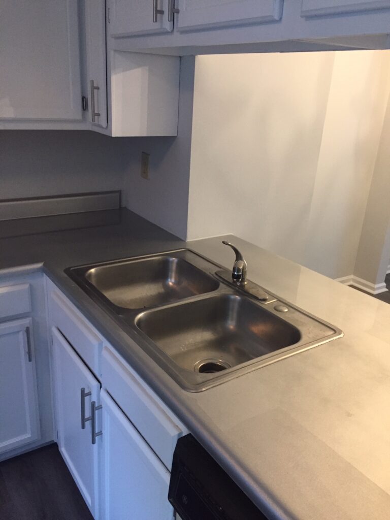 The Landlord opted to resurface in a "Silver Flakes" color, which was then top-coated in a high-gloss pour-on Epoxy (AFTER)